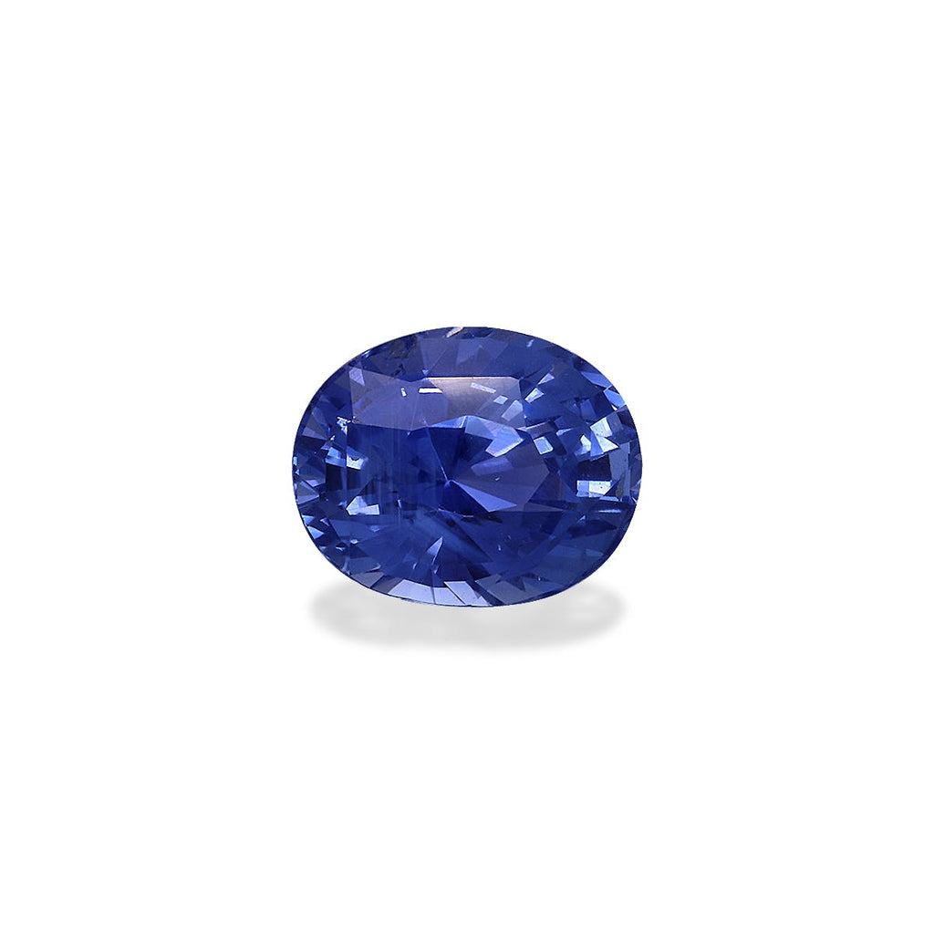 Le Saphir Bleu · 1,69 ct de Bonnot Paris est un saphir bleu vibrant de taille ovale avec une surface réfléchissante, des teintes bleu profond et des facettes de précision sur un fond blanc uni.