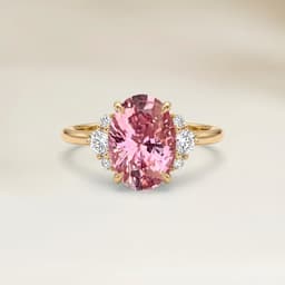 Schulterbesetzter Ring mit ovalem Padparadscha-Saphir von 0,99 ct