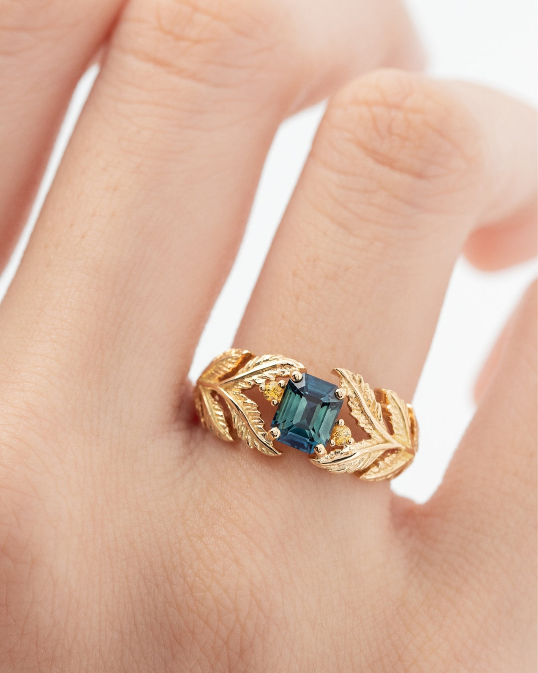 Engagement ring with teal and yellow sapphires