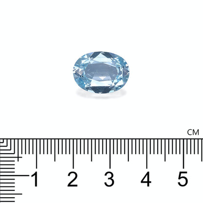 Une Aigue-Marine de 6,07 carats de Bonnot Paris, de forme ovale et bleu clair, est sertie sur un fond blanc avec une règle centimétrique en dessous pour indiquer sa taille.