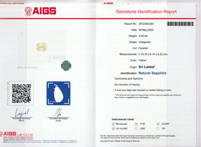 L'image présente un rapport d'identification de pierre précieuse établi par l'AIGS pour le Saphir Jaune Bonnot Paris, un saphir octogonal facetté de 5,09 carats provenant du Sri Lanka. Ce rapport confirme l'origine naturelle de la pierre, incluant mesures, notes et méthodes d'identification.