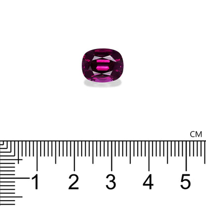 Une ombalite de grenat de 5,28 carats, de Bonnot Paris, de forme ovale et de teinte violette, est présentée sur fond blanc. Sous la pierre, une règle indique sa largeur, soit environ 1 cm.