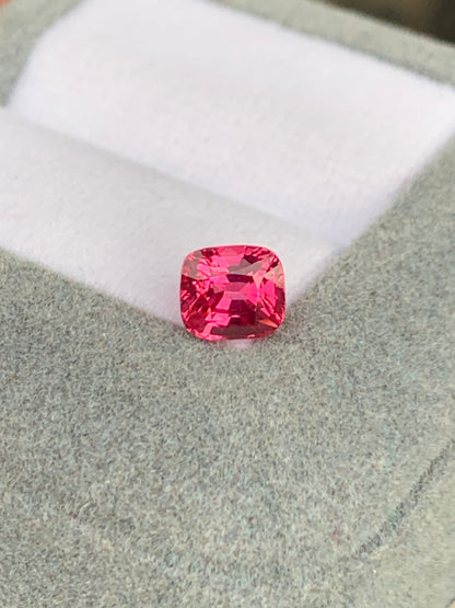 Le Spinelle Mahenge • 1,52ct de Bonnot Paris, taille coussin unique, repose élégamment sur un écrin en velours gris à l'intérieur blanc.