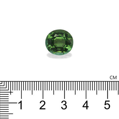 La pierre précieuse Tourmaline Verte Bonnot Paris · 6,67 ct, une petite gemme verte ronde, est présentée sur un fond blanc avec une règle centimétrique indiquant que son diamètre est légèrement inférieur à 1 cm.
