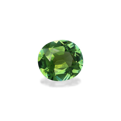 Sur un fond blanc uni, la Tourmaline Verte Bonnot Paris · 4,1ct affiche sa forme ronde facettée et sa finition brillante, révélant des reflets internes complexes et une gamme de teintes vertes allant du clair au foncé.