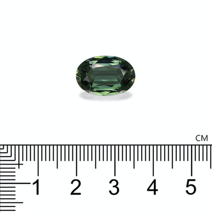 La Tourmaline Verte Bonnot Paris, pesant 6,94 carats, est une pierre précieuse verte ovale présentée sur un fond blanc uni avec une règle en dessous pour indiquer la taille en centimètres.