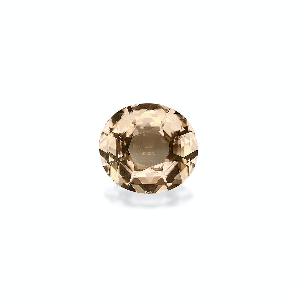 La Tourmaline Jaune de Bonnot Paris est une pierre précieuse ronde facettée de 5,98 carats, d'une teinte brun clair, posée sur un fond gris clair uni. Elle scintille subtilement, projetant une ombre subtile en dessous.
