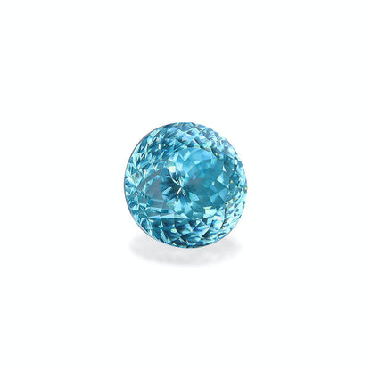 Le Zircon Bleu · 7,56 ct de Bonnot Paris est une pierre précieuse aigue-marine ronde et facettée qui présente une teinte bleue vibrante et une surface étincelante, sertie sur un fond blanc uni pour accentuer sa clarté et sa brillance.
