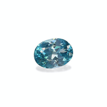 Le Zircon Bleu, une pierre précieuse de 6,12 carats de Bonnot Paris, est une pierre turquoise facettée de forme ronde qui scintille lorsque la lumière accentue ses facettes bleues et vertes sur un fond blanc.