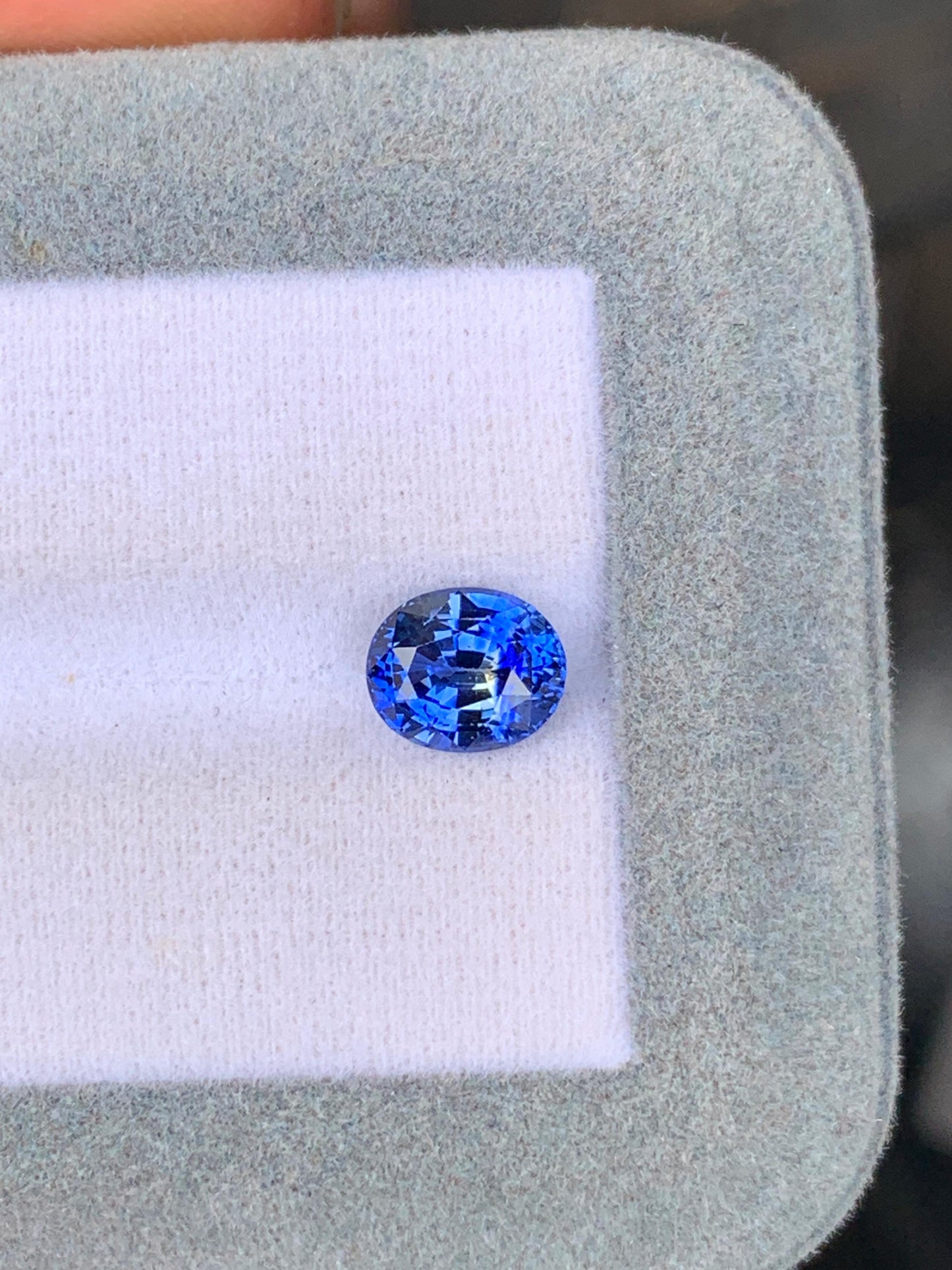 Live 35 Sapphire 2.10 ct blue oval-cut natural sapphire from Sri Lanka on white display pad